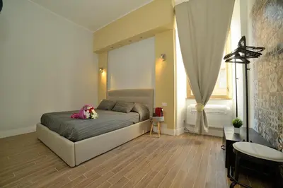 a bedroom with a bed with a teddy bear on it at La dolce casa di Giulia in Rome