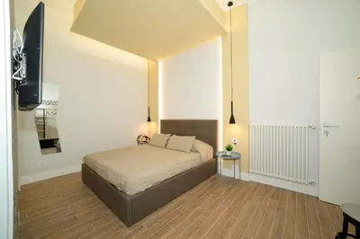 a bedroom with a bed and a television in it at La dolce casa di Giulia in Rome