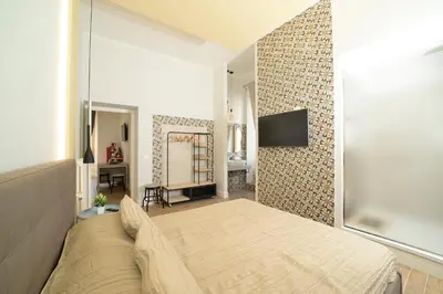 a bedroom with a bed and a tv on a wall at La dolce casa di Giulia in Rome