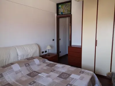 a bedroom with a bed and a dresser and a mirror at Checchi House in Rome