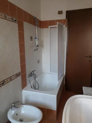 a bathroom with a tub and a toilet and a sink at Checchi House in Rome