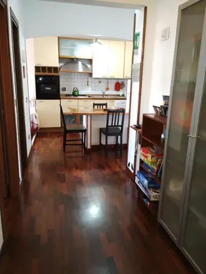 a kitchen with a table and chairs in a room at Checchi House in Rome
