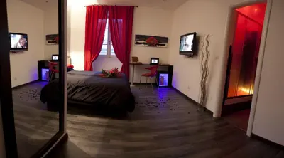 a bedroom with a bed with red curtains and a mirror at Chroma Exy - Chroma Italy in Rome