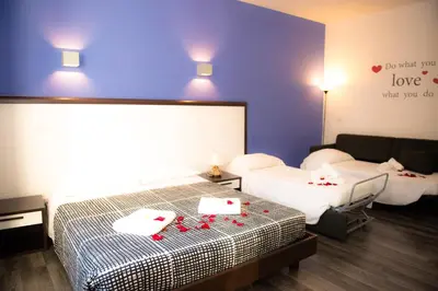 a bedroom with a bed with red candles on it at Chroma Exy - Chroma Italy in Rome