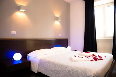 a bedroom with a bed with roses on it at Chroma Exy - Chroma Italy in Rome