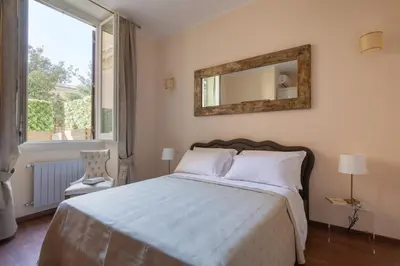 a bedroom with a bed with a mirror and a window at Vatican Domus Smart Rooms in Rome