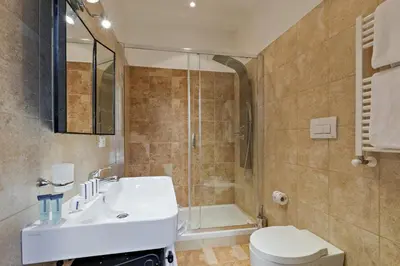a bathroom with a sink and a shower and a toilet at Vatican Domus Smart Rooms in Rome