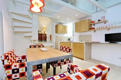 a kitchen and dining room with a table and chairs at Design Loft Campo dei Fiori in Rome