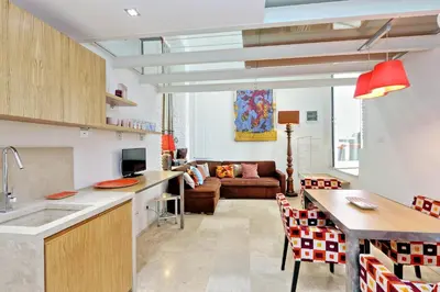 a kitchen and a living room with a couch at Design Loft Campo dei Fiori in Rome