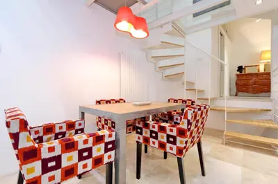 a dining room with a table and chairs at Design Loft Campo dei Fiori in Rome