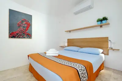 a bedroom with a bed and a painting on the wall at Design Loft Campo dei Fiori in Rome