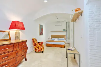 a bedroom with a bed and a desk and a dresser at Design Loft Campo dei Fiori in Rome