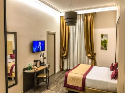 a hotel room with a bed and a desk in it at Aventino Guest House in Rome