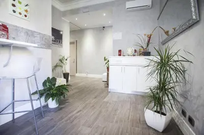 a living room with potted plants and a counter at Aventino Guest House in Rome
