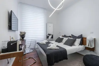 a bedroom with a bed and a desk and a tv at 500 Suite Prati delle Vittorie in Rome
