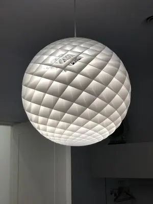 a large white light fixture hanging from a ceiling at 500 Suite Prati delle Vittorie in Rome