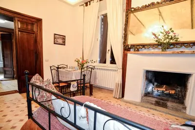 a living room with a fireplace and a mirror at St. Petrus et Aurelia in Rome