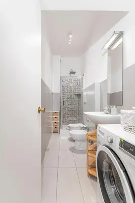 a bathroom with a washer and a toilet and a sink at La casa di Effe in Rome