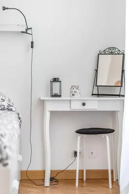 a white desk with a mirror and a stool at La casa di Effe in Rome