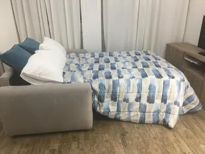 a bed and a couch in a room at Mamma Roma 151 in Rome