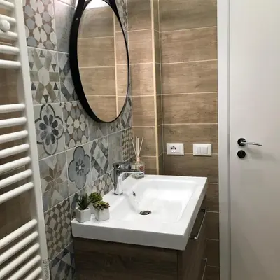 a bathroom with a sink and a mirror at Mamma Roma 151 in Rome