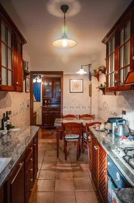 a kitchen with a table and a dining room at Regal House Roma Navigatori 23 in Rome