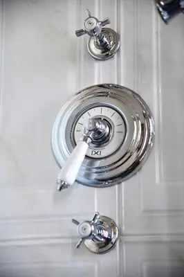 a chrome sink with three knobs on a white door at Regal House Roma Navigatori 23 in Rome