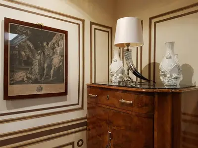 a lamp on top of a dresser in a room at Regal House Roma Navigatori 23 in Rome