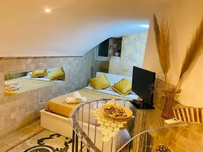 a small room with a bed and a glass table at Ancient Roman Mansion in Rome