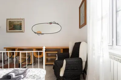 a room with a table and chairs and a mirror at Casa Vacanze Casilina in Rome