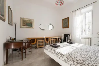 a bedroom with a bed and a desk and a table at Casa Vacanze Casilina in Rome