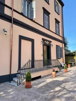 a building with potted plants in front of it at Casa Vacanze Casilina in Rome