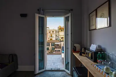 an open door with a view of a city at President Gardens in Rome