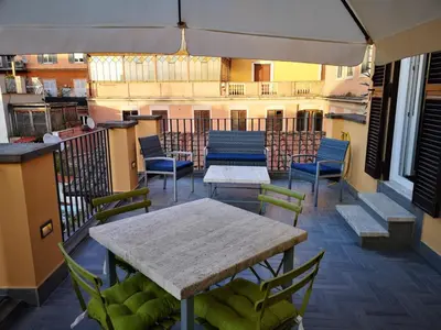a balcony with a table and chairs on a balcony at President Gardens in Rome