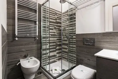 a bathroom with a shower and a toilet and a sink at President Gardens in Rome