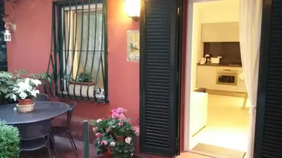a room with a table and a window and a table and a door at La Calla al Colosseo in Rome