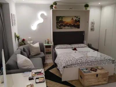 a small bedroom with a bed and a couch at La Calla al Colosseo in Rome