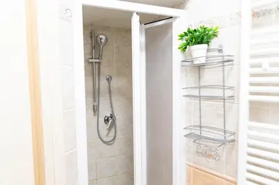 a bathroom with a shower with a glass door at Sunny Home in Rome
