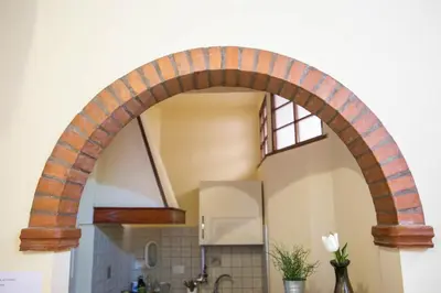 an archway in a kitchen with a sink at Sunny Home in Rome
