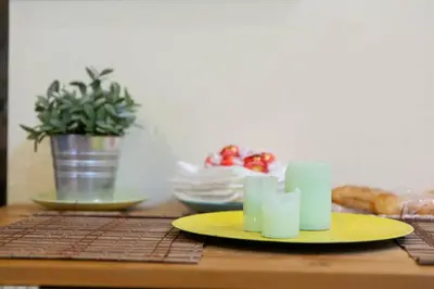 a table with a yellow plate on a table at Sunny Home in Rome