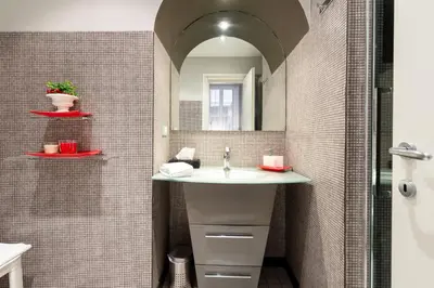 a bathroom with a sink and a mirror at Rome in your heart - Spagna Single Room in Rome