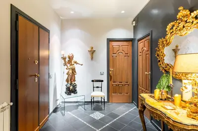 a hallway with a door and a gold mirror at Rome in your heart - Spagna Single Room in Rome