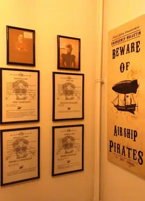 a wall with framed pictures of an airplane on it at San Paolo Steampunk Flat in Rome