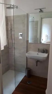 a bathroom with a sink and a glass shower at Vatican Home in Rome - Suite St. Peter's View in Rome