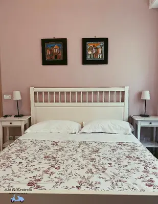 a bedroom with a large bed with two tables at Ale&Andrea Apartments BLU & LILLA in Rome