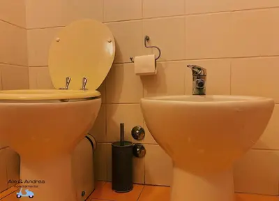 a bathroom with a toilet and a sink at Ale&Andrea Apartments BLU & LILLA in Rome