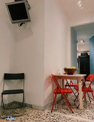 a room with a table and two chairs and a tv at Ale&Andrea Apartments BLU & LILLA in Rome