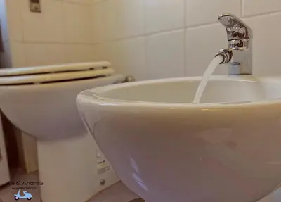 a bathroom with a sink and a toilet at Ale&Andrea Apartments BLU & LILLA in Rome