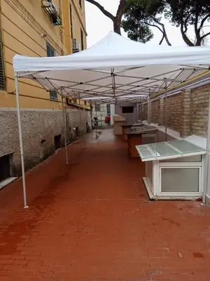 a white umbrella sitting on a brick sidewalk at L'attico di Val. in Rome