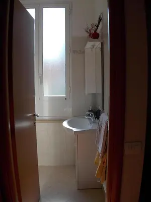 a bathroom with a sink and a window at L'attico di Val. in Rome